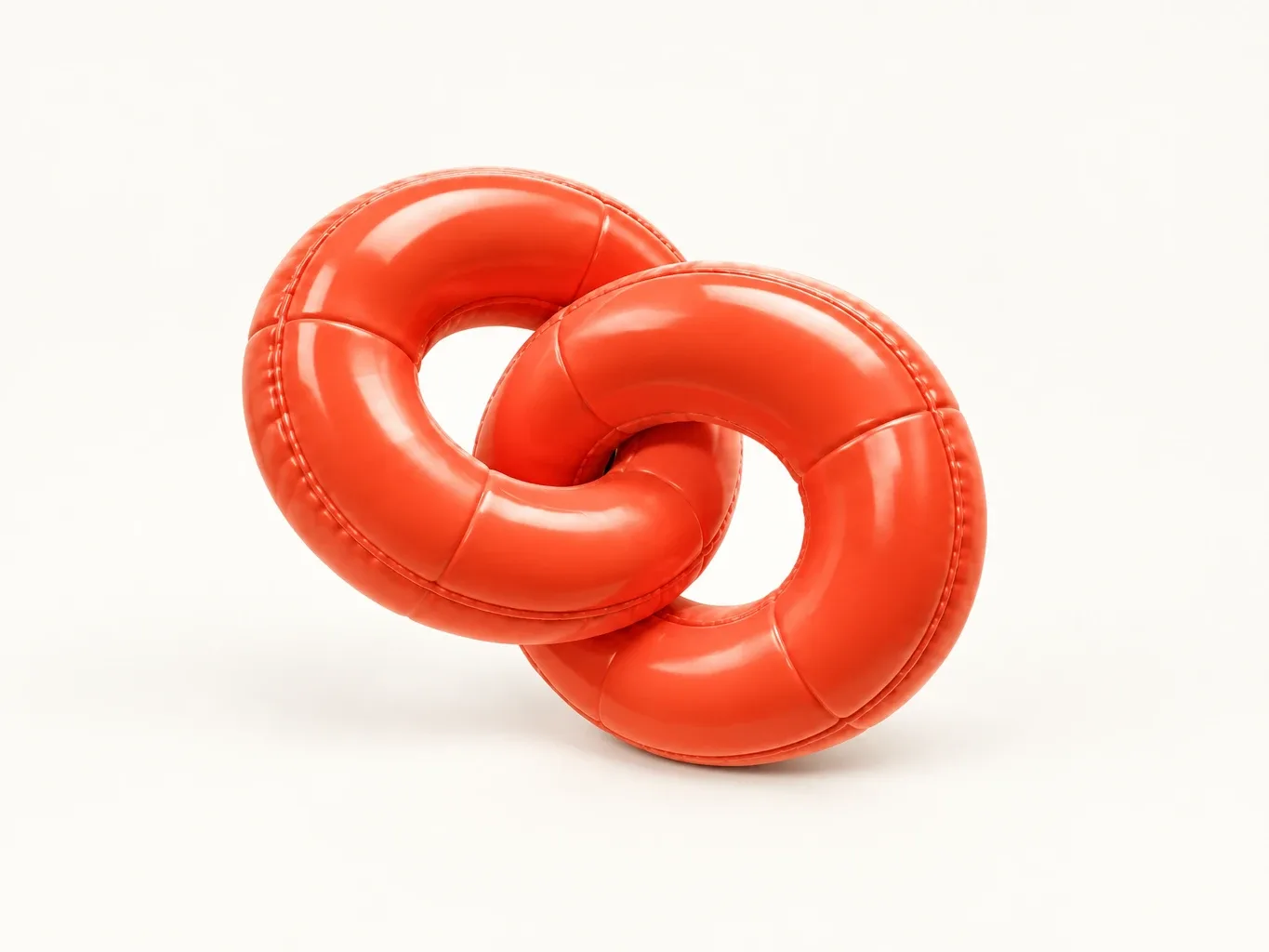 Two inflated puffy coral-red rings interlocked like chain links, cream highlights