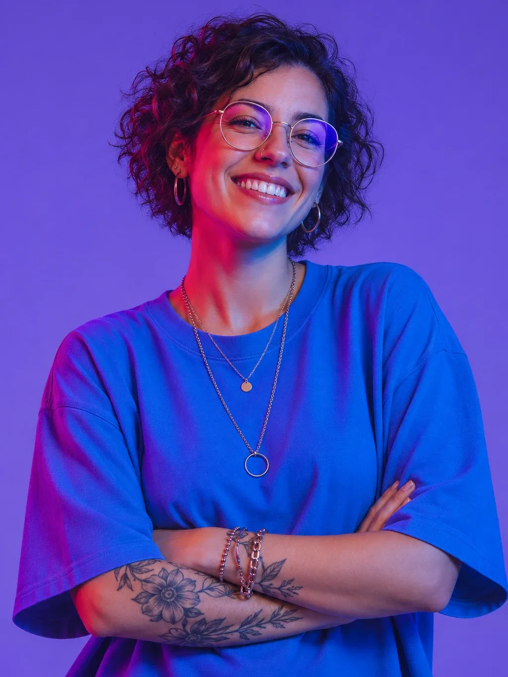 Priya Nair, founder of Halo, smiling with round glasses