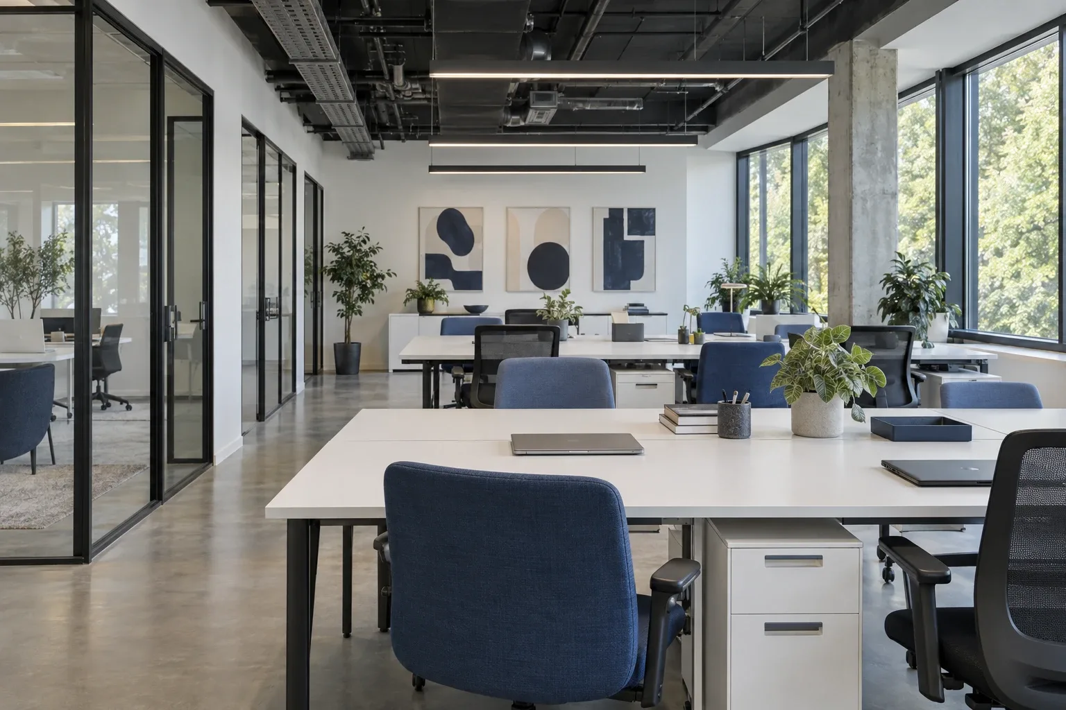 Modern open office with glass partitions and blue swivel chairs