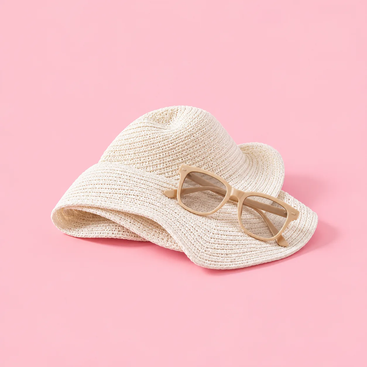 White sun hat and neutral sunglasses illustrating general sun-protection guidance.