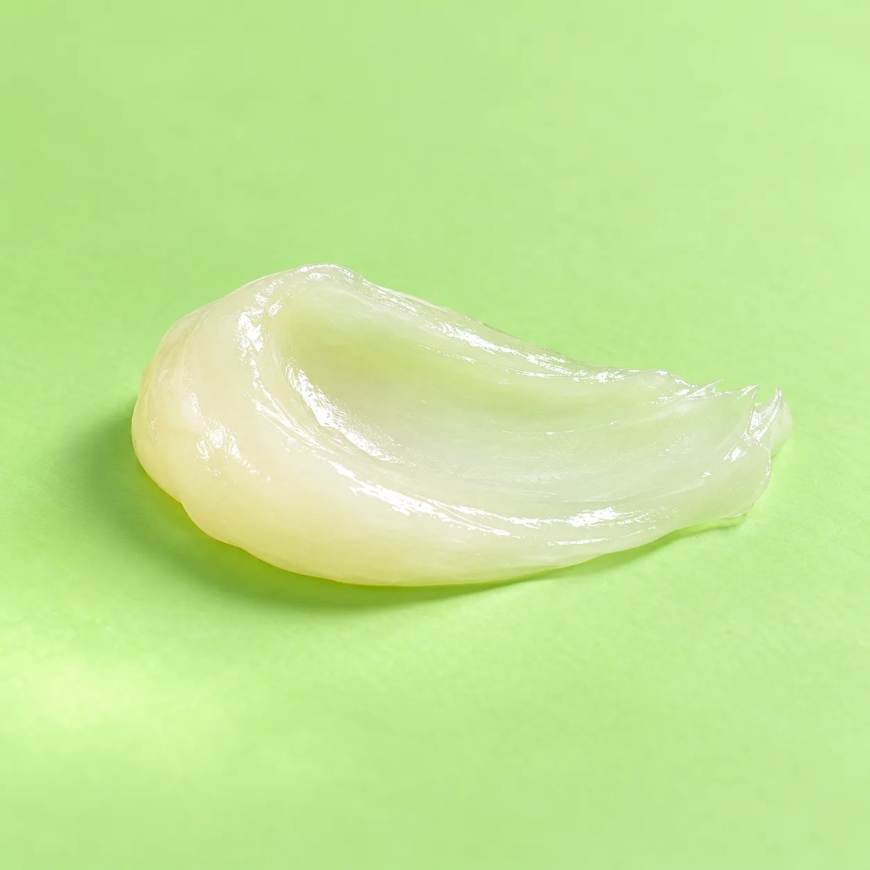 A soft translucent balm swoosh illustrating a quiet daily pause.